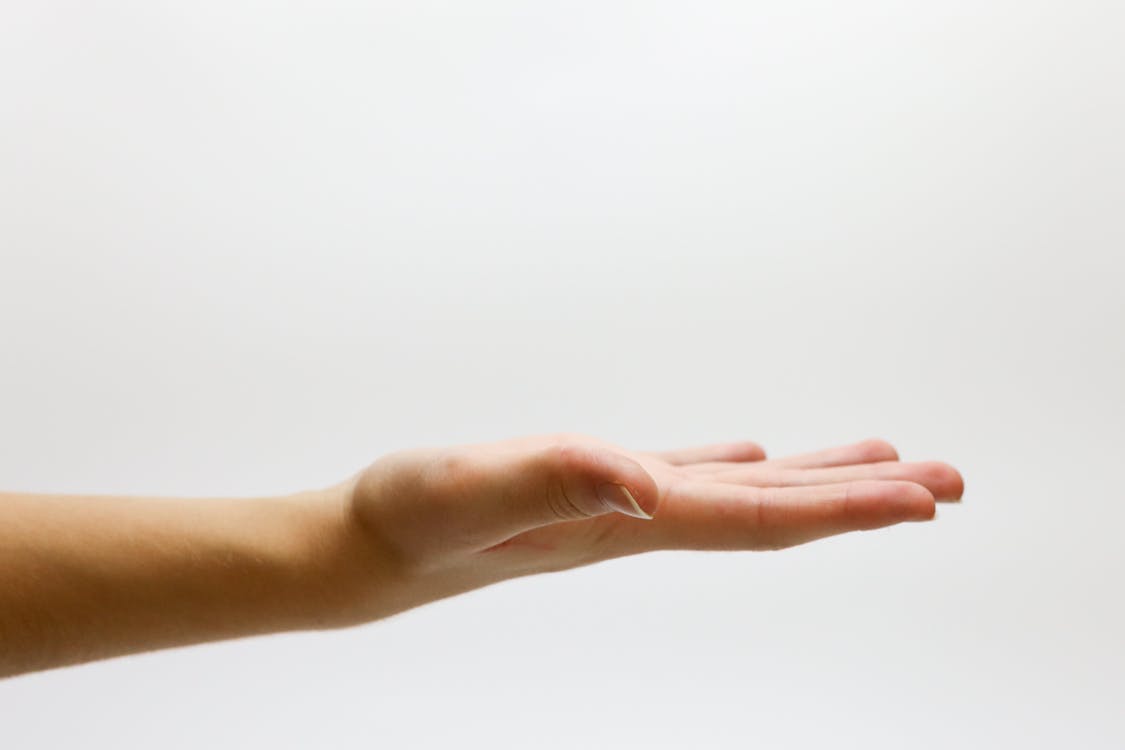 A person doing the wrist flexion exercises.